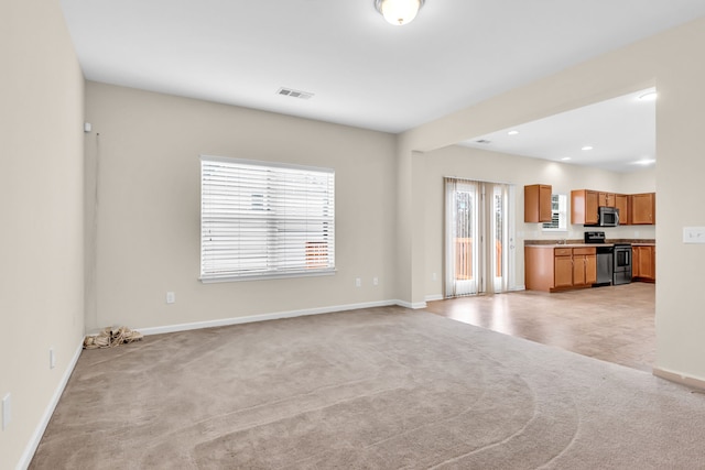 unfurnished living room with light carpet