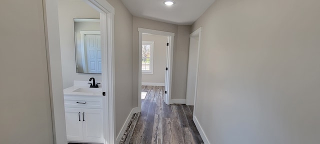 hall with dark hardwood / wood-style flooring and sink