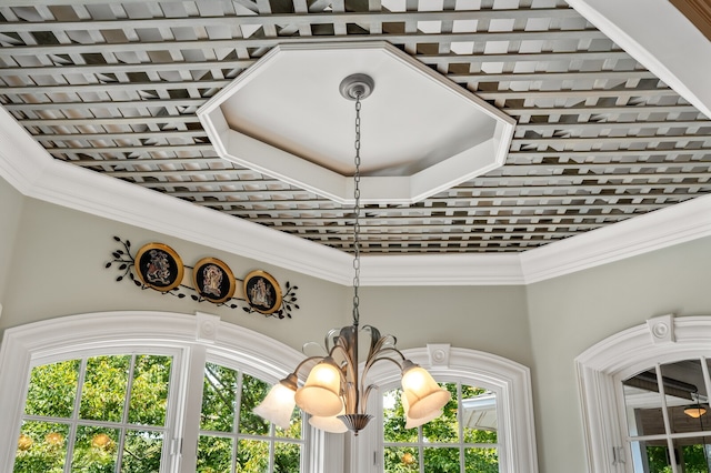 interior details with ornamental molding and an inviting chandelier