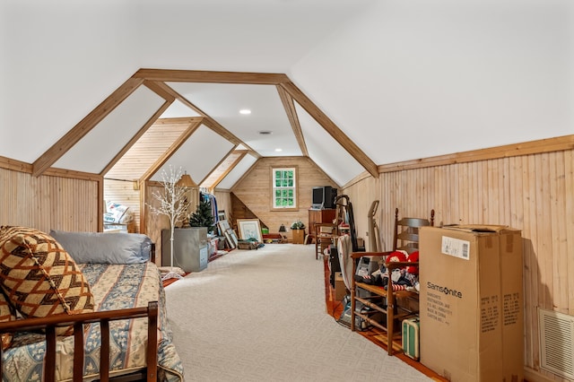 bedroom featuring carpet, wooden walls, and vaulted ceiling with beams