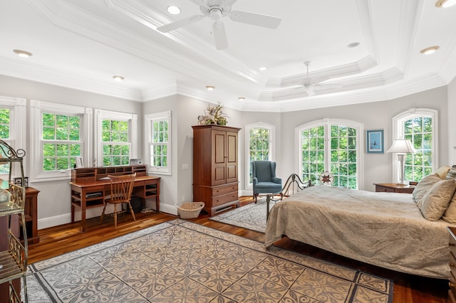 bedroom featuring crown molding, hardwood / wood-style flooring, and multiple windows