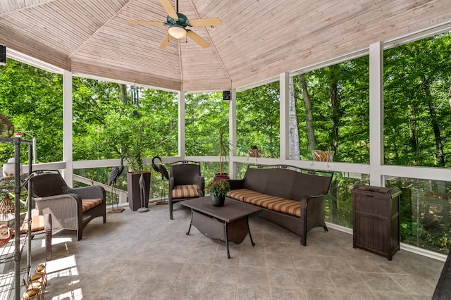 sunroom / solarium featuring lofted ceiling, plenty of natural light, ceiling fan, and wooden ceiling