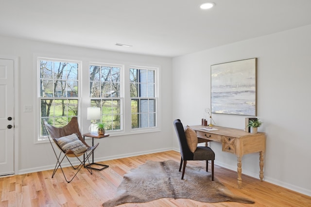 office featuring a wealth of natural light and light hardwood / wood-style flooring