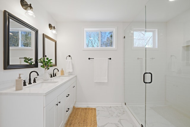 bathroom with a wealth of natural light, a shower with shower door, and vanity