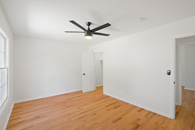 empty room with light hardwood / wood-style floors and ceiling fan