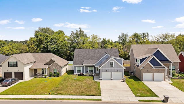 view of front of house with board and batten siding, a front yard, concrete driveway, and a garage