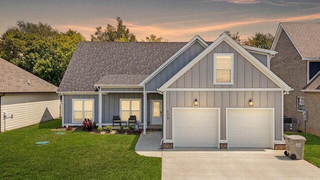 view of front of property with a yard and a garage