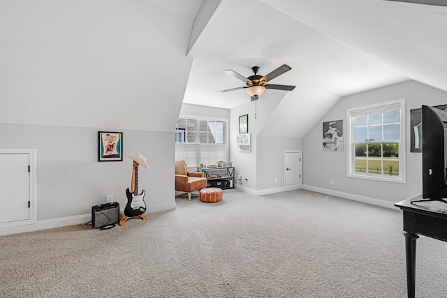 bonus room with vaulted ceiling, carpet flooring, a ceiling fan, and baseboards