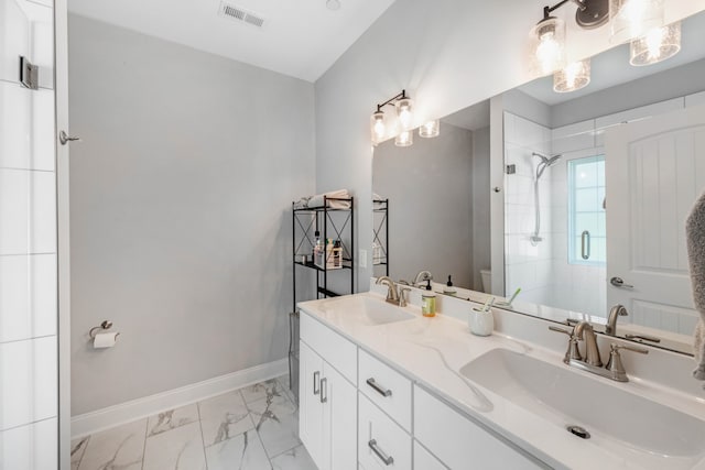 full bathroom featuring toilet, a sink, visible vents, baseboards, and a stall shower