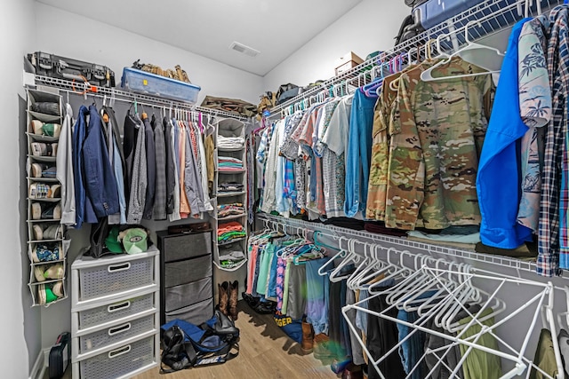 spacious closet featuring visible vents and wood finished floors