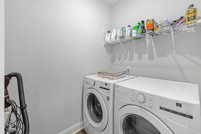 laundry area featuring laundry area, washer and clothes dryer, and baseboards