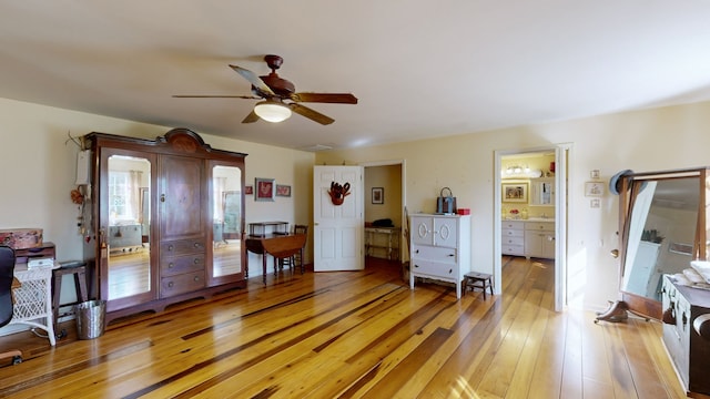 interior space featuring hardwood / wood-style floors, ensuite bath, and ceiling fan