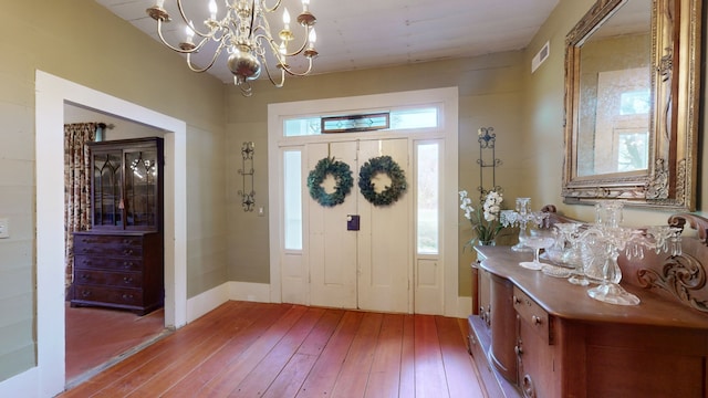 entryway featuring hardwood / wood-style floors, a healthy amount of sunlight, and a notable chandelier