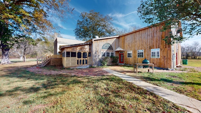 rear view of property with a lawn