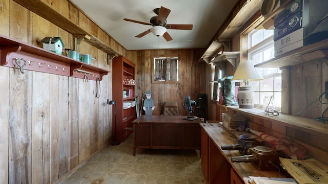 kitchen with wooden walls and ceiling fan