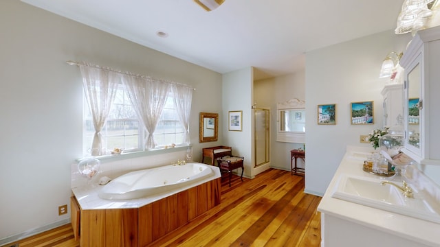 bathroom featuring vanity, hardwood / wood-style floors, and separate shower and tub