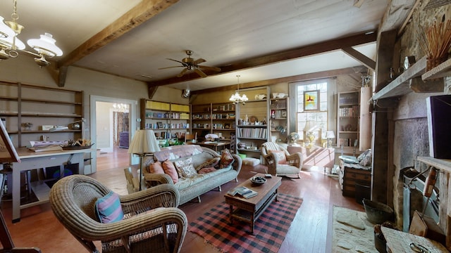 living room with ceiling fan with notable chandelier, beamed ceiling, and hardwood / wood-style flooring