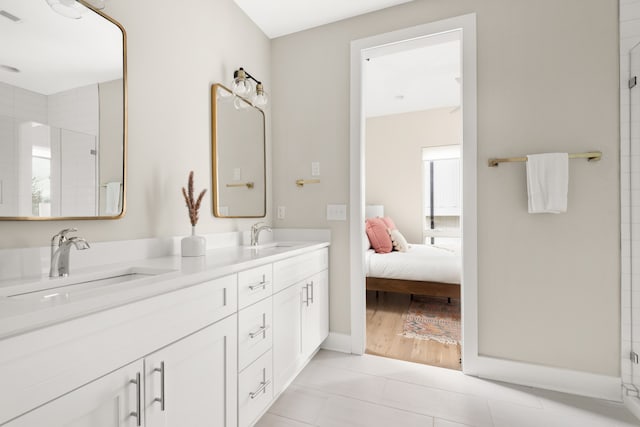 bathroom with a shower with shower door, vanity, and wood-type flooring