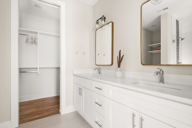 bathroom with vanity, wood-type flooring, and a shower