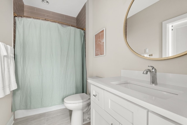 full bathroom featuring tile patterned flooring, vanity, toilet, and shower / tub combo with curtain