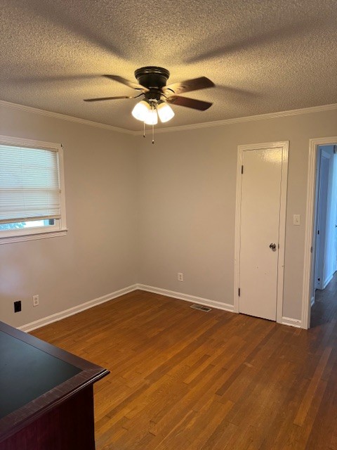 empty room with ceiling fan, hardwood / wood-style flooring, and a textured ceiling