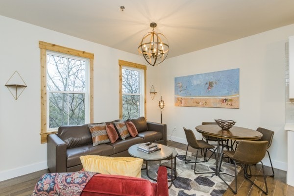 living room with a notable chandelier and hardwood / wood-style flooring