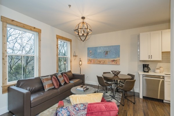 living room featuring a notable chandelier and dark hardwood / wood-style floors