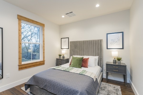 bedroom with dark hardwood / wood-style floors