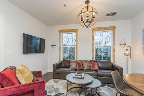 living room featuring hardwood / wood-style floors and an inviting chandelier