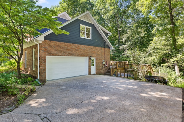 view of property exterior featuring a wooden deck and a garage