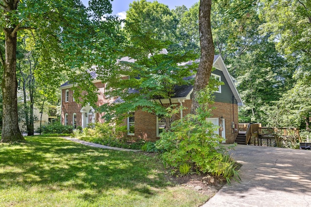 view of side of home featuring a wooden deck and a lawn