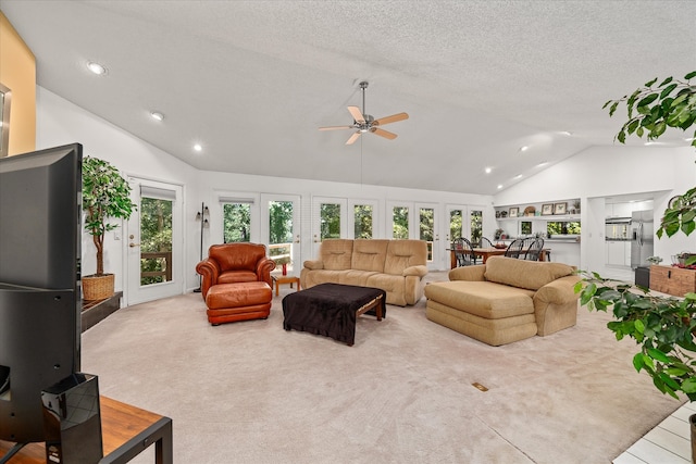 living room featuring lofted ceiling, ceiling fan, plenty of natural light, and french doors