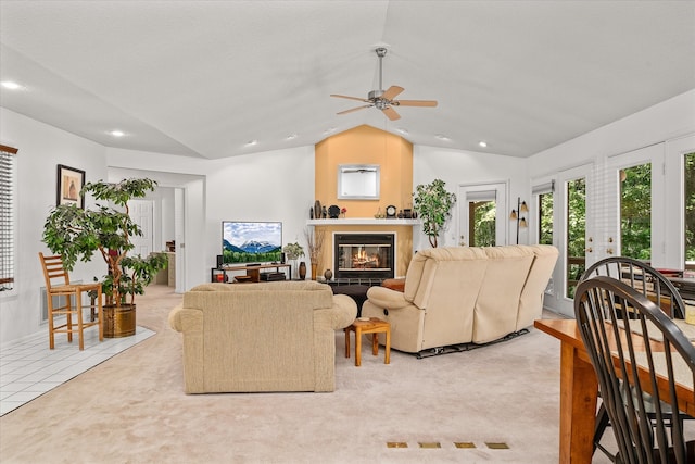 living room featuring lofted ceiling, light colored carpet, and ceiling fan