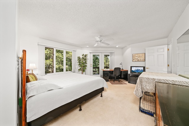 carpeted bedroom featuring french doors, a textured ceiling, access to exterior, and ceiling fan