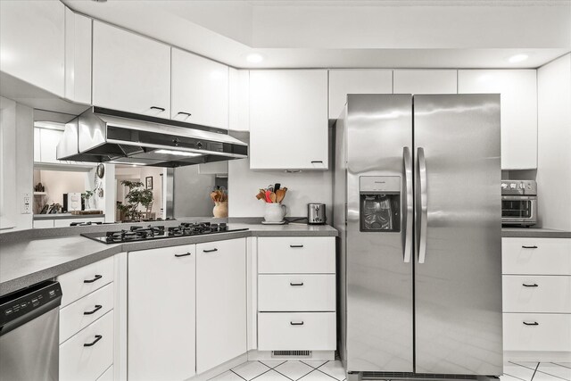 kitchen featuring white cabinets, light tile patterned floors, and stainless steel appliances