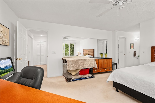 carpeted bedroom with a textured ceiling and ceiling fan