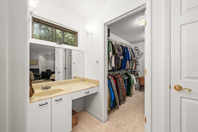 bathroom with a textured ceiling and vanity