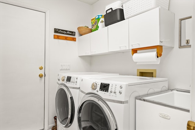 washroom featuring independent washer and dryer, cabinets, and sink