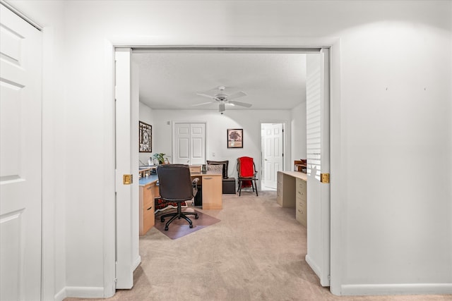 office area with ceiling fan and light carpet