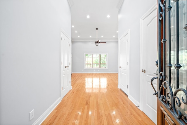 entryway featuring crown molding, recessed lighting, a ceiling fan, light wood-type flooring, and baseboards