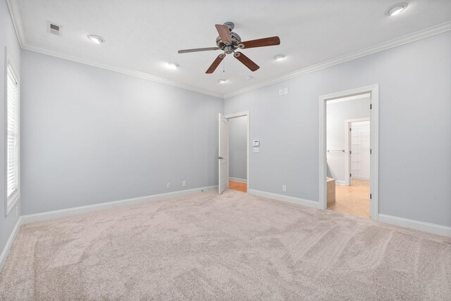 unfurnished bedroom featuring ornamental molding, ceiling fan, and light colored carpet