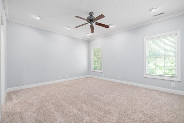 unfurnished room featuring ceiling fan, a wealth of natural light, and light colored carpet