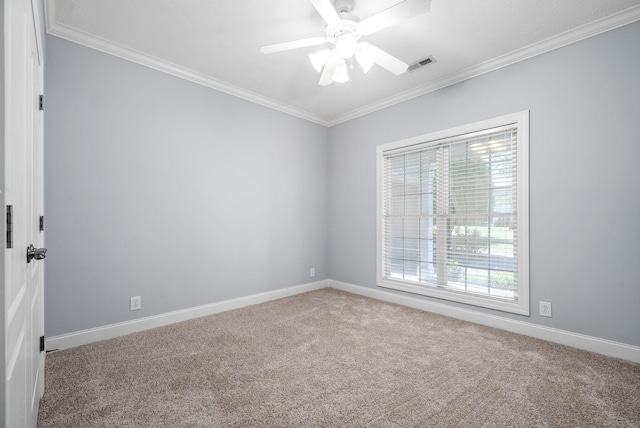 carpeted spare room featuring ornamental molding, a healthy amount of sunlight, and baseboards