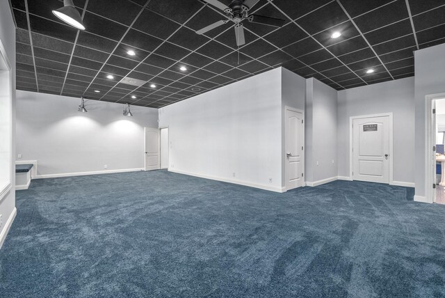 unfurnished room featuring ceiling fan and carpet floors