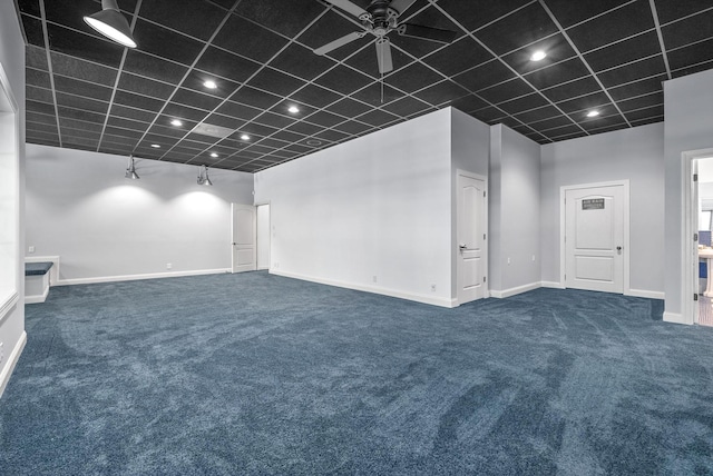 spare room featuring baseboards, ceiling fan, a high ceiling, dark colored carpet, and recessed lighting