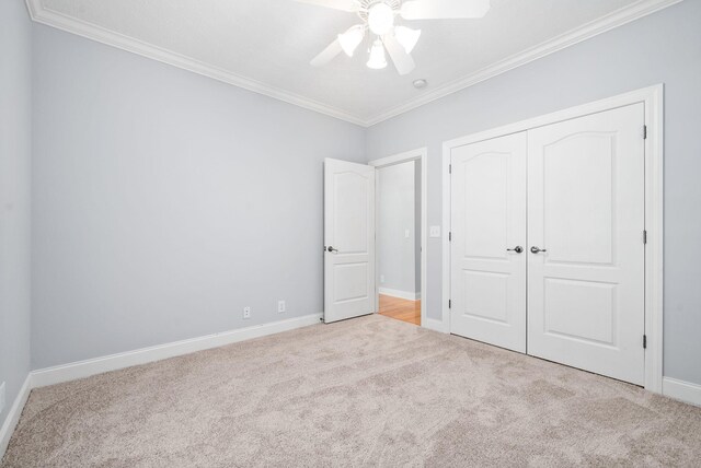 unfurnished bedroom featuring light carpet, ornamental molding, and ceiling fan