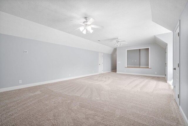 bonus room featuring ceiling fan, light colored carpet, a textured ceiling, and vaulted ceiling