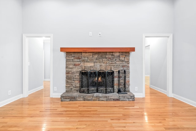 unfurnished living room with a fireplace and light hardwood / wood-style floors