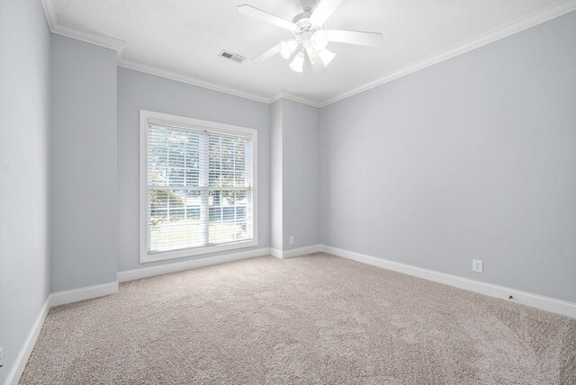 empty room featuring light colored carpet, ceiling fan, and ornamental molding