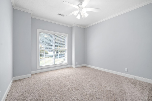 empty room with ornamental molding, carpet flooring, visible vents, and baseboards